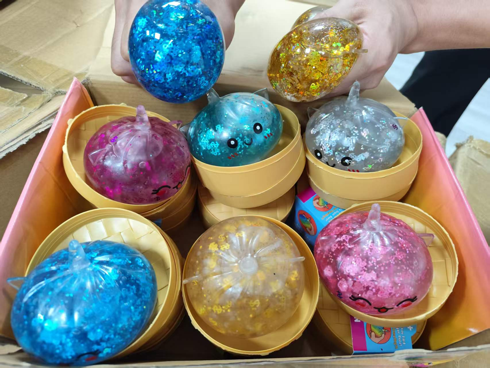 Glitter dumpling squishy balls in multiple sparkly colors in basket containers